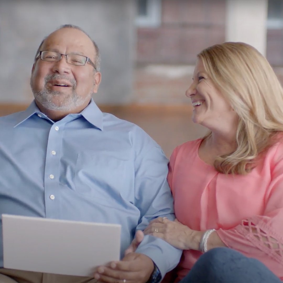 A husband and wife share a smile together.